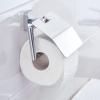 Chromowany uchwyt Tesa ELEGAANT z rolką papieru zamontowany na białych płytkach łazienkowych