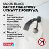 Czarny metalowy uchwyt Tesa MOON z pokrywą prezentuje nowoczesny design na tle jasnej ściany